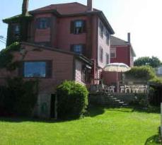 Homestead Inn: House rear, yard, deck, trellis