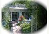 Yellow Turtle Inn: Entrance to glass garden room