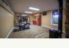 320 Whistle Creek Dr: Exercise room on lower level with wall mirror